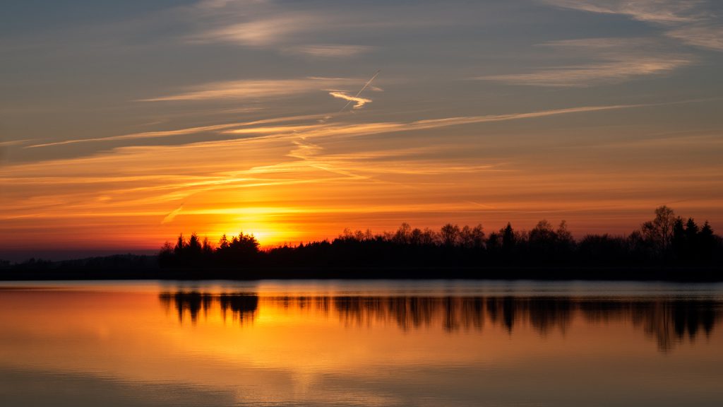 landscape photo of a sunset reflection on a cold evening along a lake in Coo, East Belgium