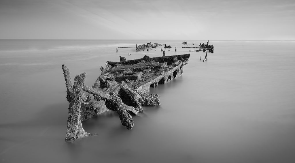 black and white extended exposure photo of a shipwreck in Northern France