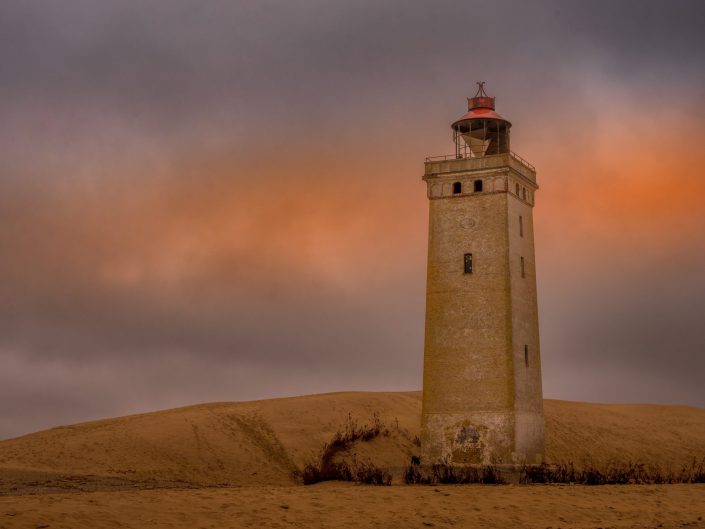 Landscape photo at sunset of a lighthouse in the dunes of Denmark