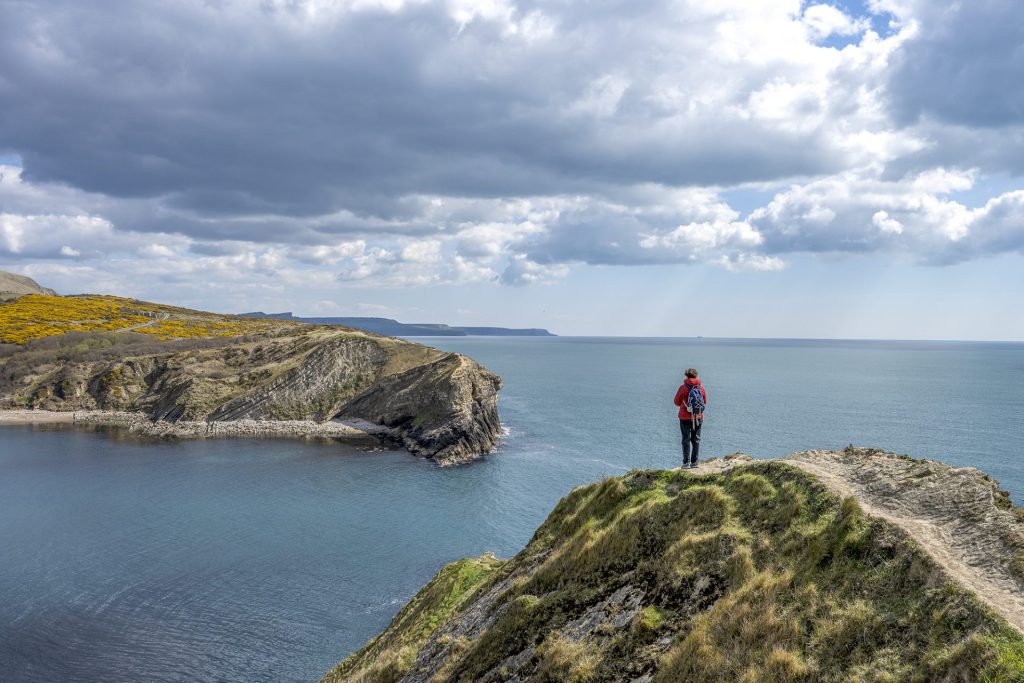 Seascape photo with a path as a leading line and a person as focal point