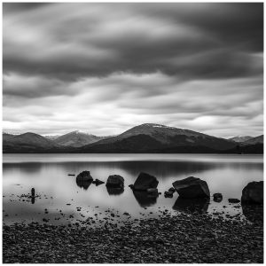 Black-and-white long exposure seascape with rocks as leading line