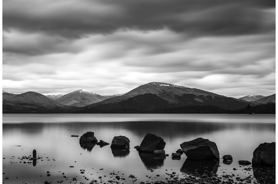 Black-and-white long exposure seascape with rocks as leading line
