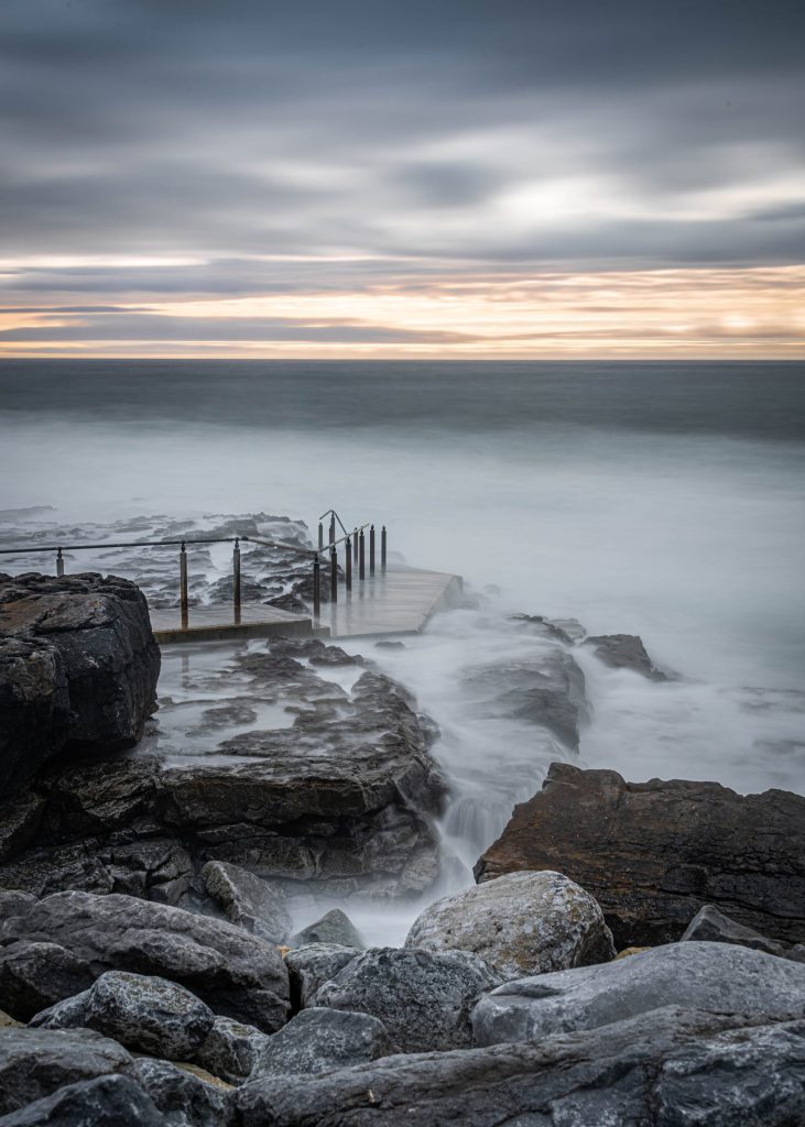 25 second exposure of waves over the stairs and the rocks