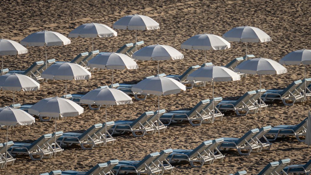 beach photo of seats and parasols lined up
