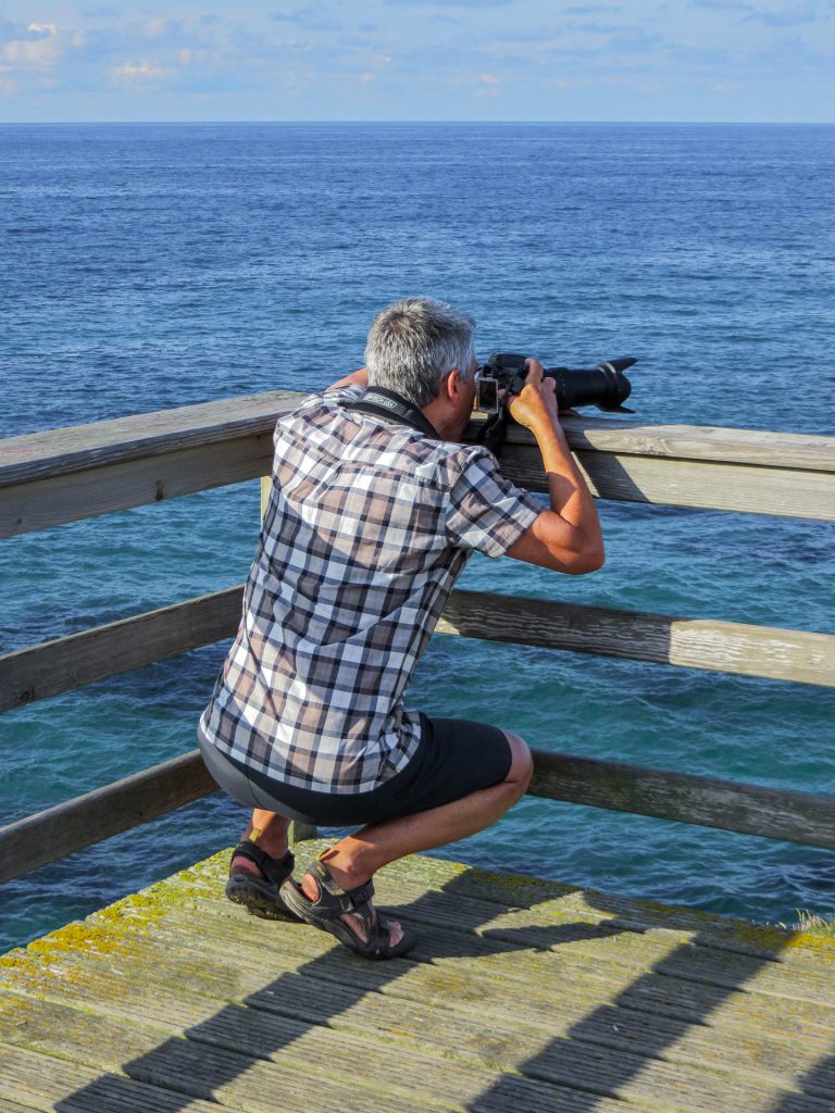 seascape with photographer using the railing as a tripod