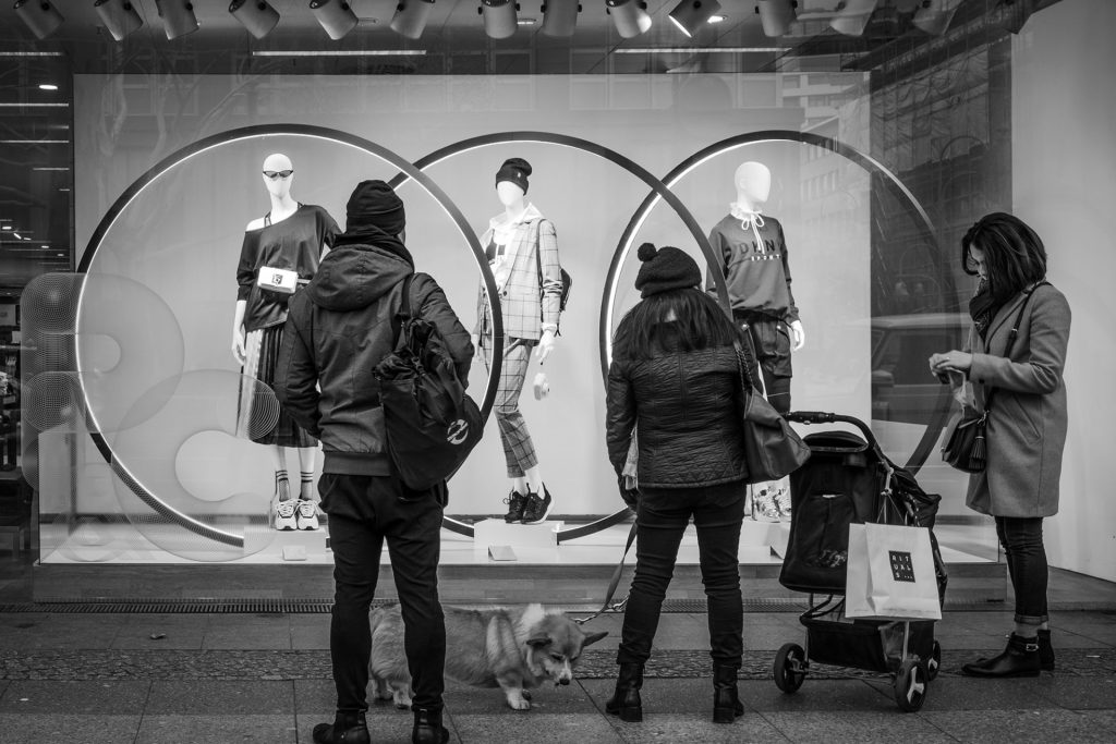 Street Photo in black and white of people in front of a shop window