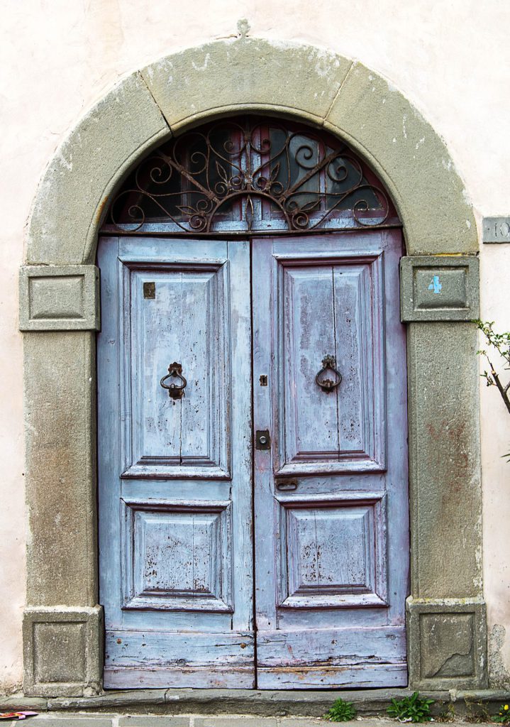 Architectural photo of an old weathered door in Tuscany, Italy