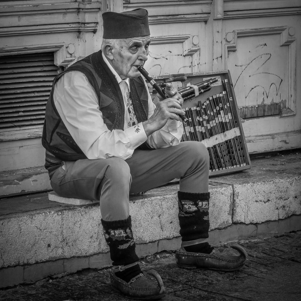 street photo of a traditional flute player in Belgrade, Serbia